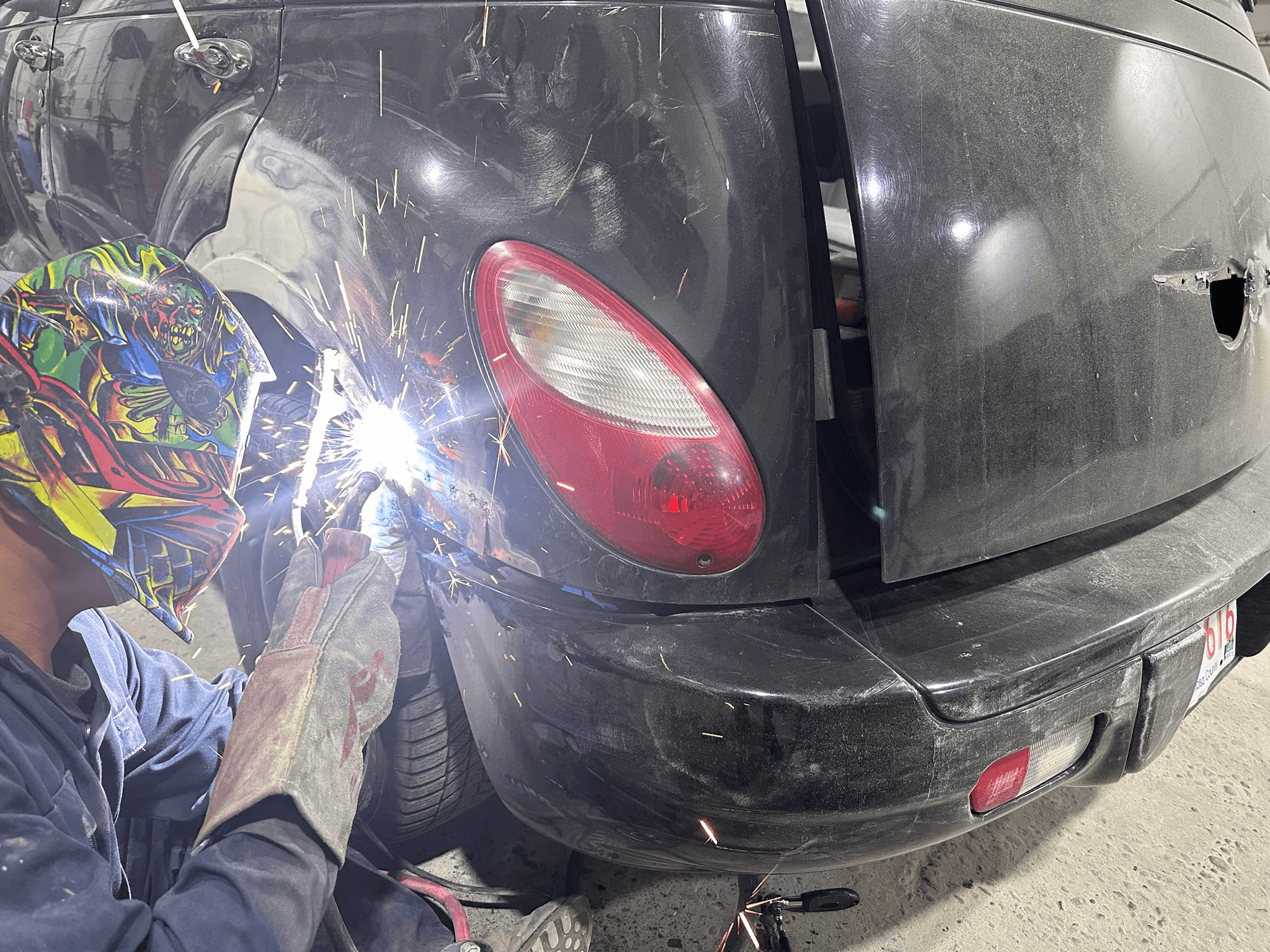 Auto body technician fixing car