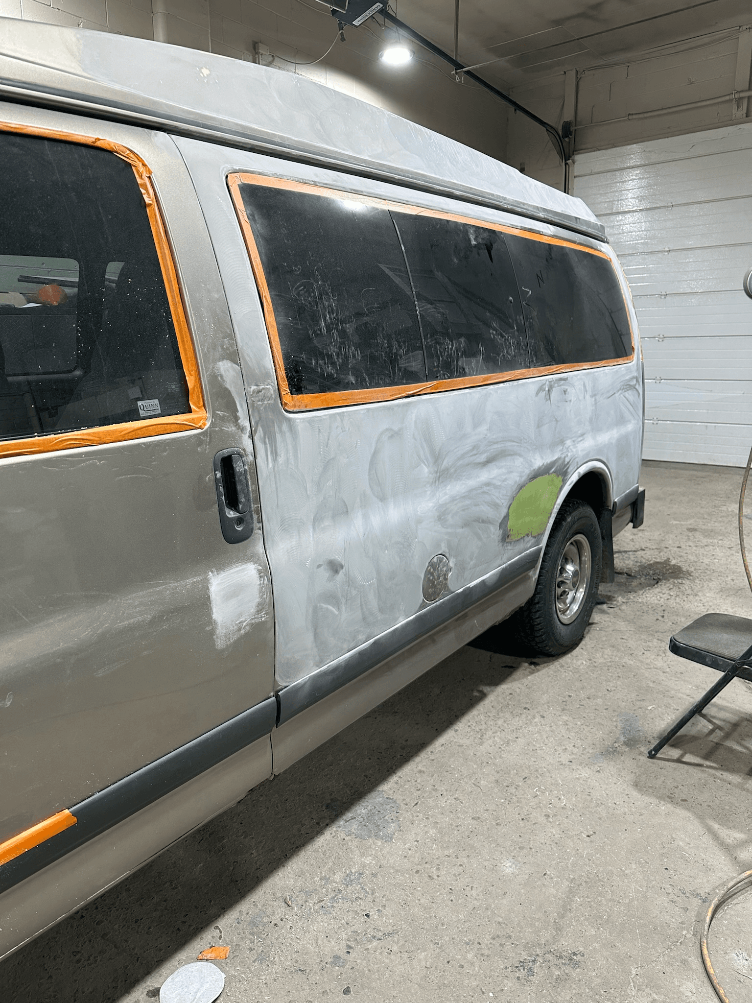 Auto body specialist applying paint